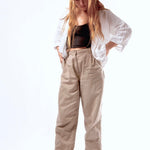 Woman in casual outfit looking down wearing Indosole sea salt slides