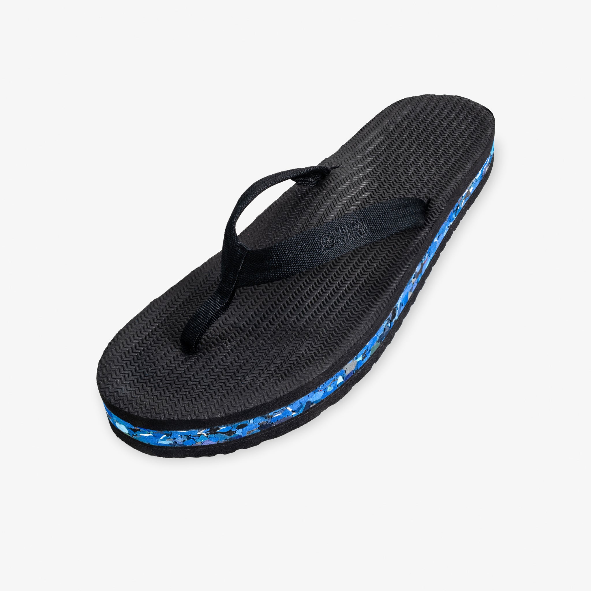 Indosole Women's Riversole flip flop in black with blue recycled shore sole — three-quarter view