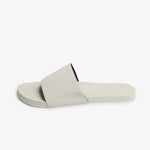 Side profile of sea salt sneaker sole slide in soft off-white cream